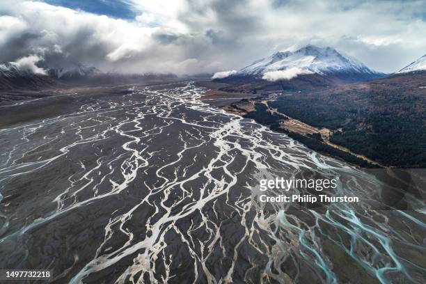aerial perspective of river braid system from glacial runoff with dramatic snow covered mountains - verdigris river bildbanksfoton och bilder