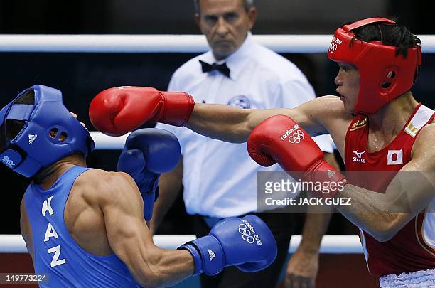 Yasuhiro Suzuki of Japan defends against Serik Sapiyev of Kazakhstan during their round of 16 Welterweight match of the London 2012 Olympic Games at...