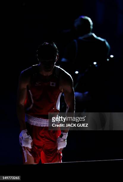 Yasuhiro Suzuki of Japan leaves the ring following his loss to Serik Sapiyev of Kazakhstan in their round of 16 Welterweight match of the London 2012...