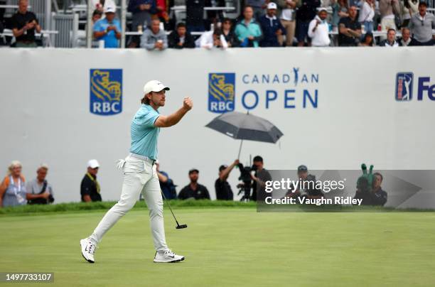 Tommy Fleetwood of England reacts on the 18th green after making a putt on the first playoff hole to force a second playoff during the final round of...