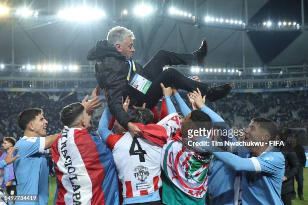 Players of Uruguay celebrate with Marcelo Garcia, auxiliary coach of Uruguay following the team's victory during the FIFA U-20 World Cup Argentina...