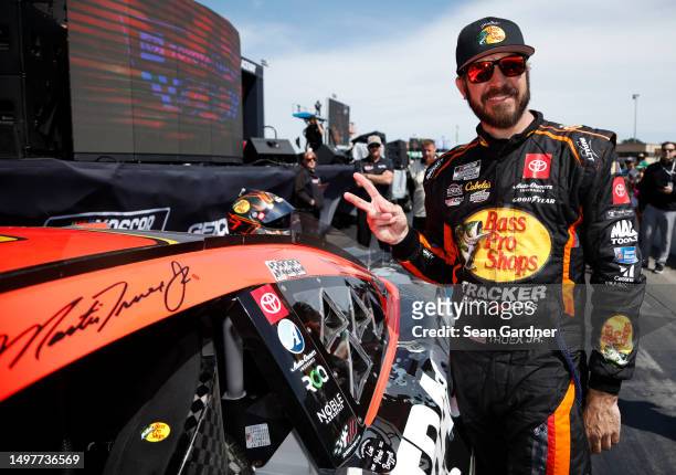 Martin Truex Jr., driver of the Bass Pro Shops Toyota, poses next to his winner sticker in victory lane after winning the NASCAR Cup Series Toyota /...