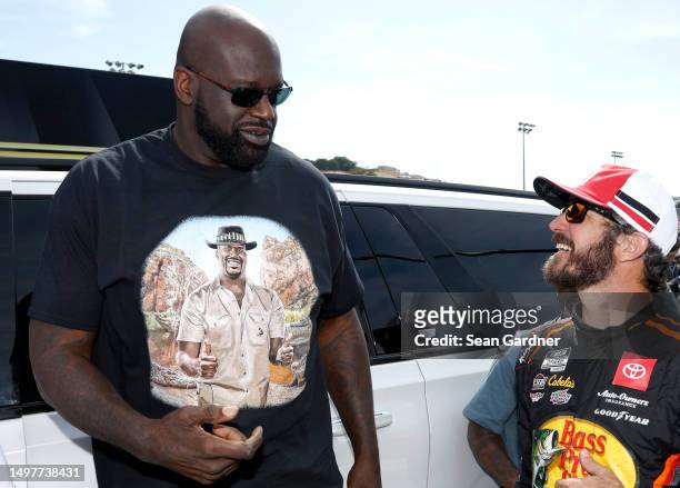 Shaquille O'Neal congratulates Martin Truex Jr., driver of the Bass Pro Shops Toyota, in victory lane after winning the NASCAR Cup Series Toyota /...