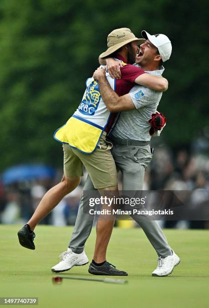 Nick Taylor of Canada celebrates with his caddie after making an eagle putt on the 4th playoff hole to win the RBC Canadian Open at Oakdale Golf &...