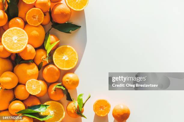 top view of juicy ripe oranges on white table. copy space background. juice making - tangerine stock pictures, royalty-free photos & images