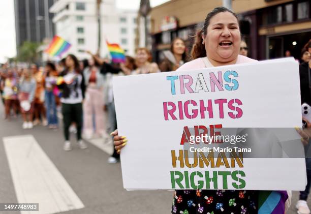 Participant holds a 'Trans Rights Are Human Rights' sign during the 2023 LA Pride Parade in Hollywood on June 11, 2023 in Los Angeles, California....