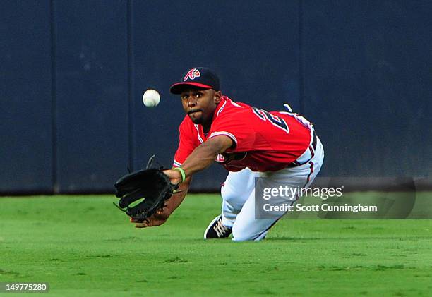 Michael Bourn of the Atlanta Braves is unable to make a catch against the Houston Astros at Turner Field on August 3, 2012 in Atlanta, Georgia.