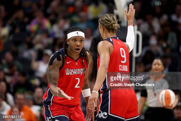 Myisha Hines-Allen and Natasha Cloud of the Washington Mystics react during the fourth quarter against the Seattle Storm at Climate Pledge Arena on...