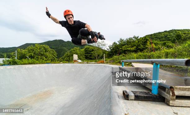 a middle age man getting air inline skating at a skate park - inline skating man park stock pictures, royalty-free photos & images