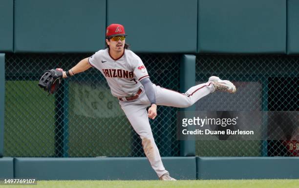 Left fielder Corbin Carroll of the Arizona Diamondbacks watches his throw on a ball hit by Spencer Torkelson of the Detroit Tigers for a double...