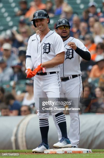 First base coach Alfredo Amezaga of the Detroit Tigers talks with Kerry Carpenter after his single against the Arizona Diamondbacks during the third...