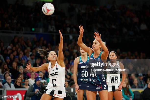 Liz Watson of the Vixens passes the ball under pressure from Molly Jovic of the Magpies during the round 13 Super Netball match between Melbourne...