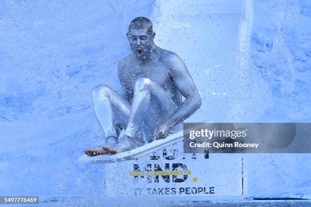 Mick Fanning, Australian surfer, goes down the slide for FightMND Big Freeze 9, ahead of the round 13 AFL match between Melbourne Demons and...