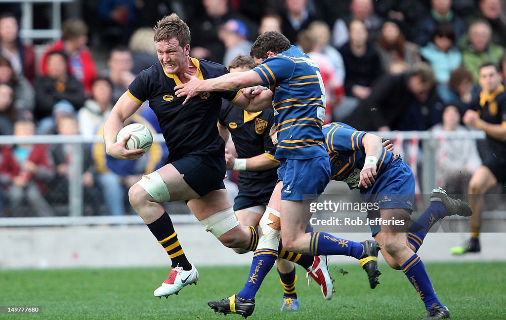 Dunedin Razorbacks Gareth Evans of Dunedin breaks the tackle of Ryan Hammer during the ...
