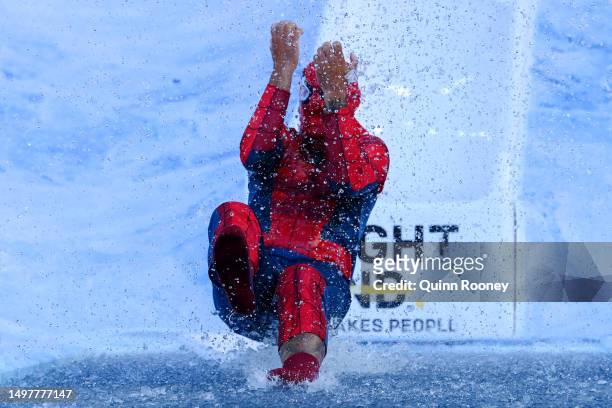 Shaun Burgoyne, former AFL player, goes down the slide for FightMND Big Freeze 9, ahead of the round 13 AFL match between Melbourne Demons and...