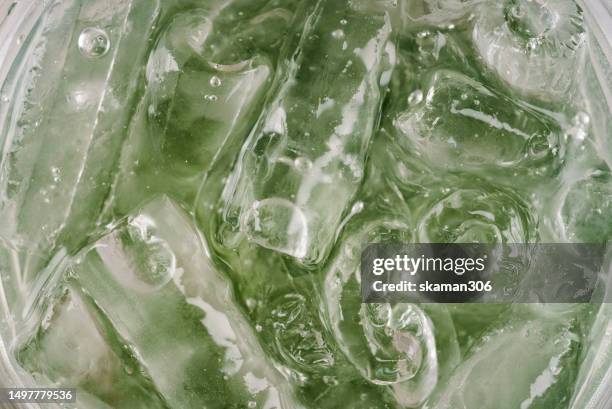 close up ice cube and sparking soda water with colorful colors cup - a vodka soda with lime stock pictures, royalty-free photos & images