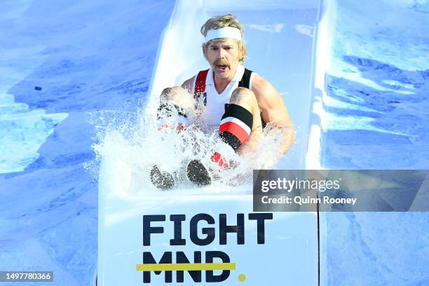 Eric Bana, Australian actor, goes down the slide for FightMND Big Freeze 9, ahead of the round 13 AFL match between Melbourne Demons and Collingwood...