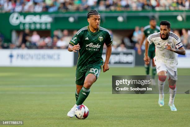 Evander of the Portland Timbers dribbles away from Jesus Ferreira of the FC Dallas during the first half at Providence Park on June 11, 2023 in...