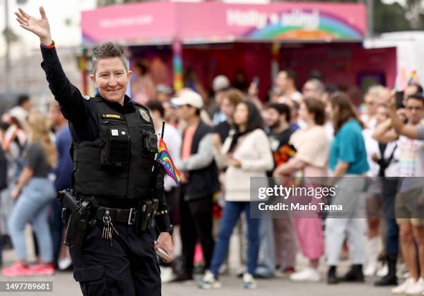 Long Beach Police Department officer waves while participating in the 2023 LA Pride Parade in Hollywood on June 11, 2023 in Los Angeles, California....