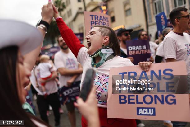 March participants chant and hold signs in support of rights for transgender people and drag performers during the 2023 LA Pride Parade in Hollywood...