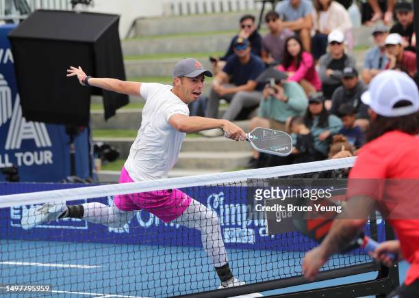 Ben Johns leaps over the kitchen for a forehand erne shot against Tyson McGuffin and Catherine Parenteau during the PPA Pro Mixed Doubles Finals at...