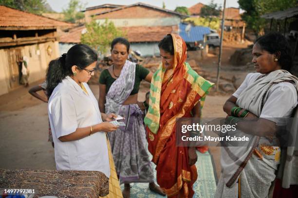 the doctor explaining medicine dosage and giving out medicines to village women during a medical health care camp. - primary care stock pictures, royalty-free photos & images