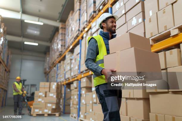 multiracial warehouseman receiving and processing warehouse stock products - trabajador de almacén fotografías e imágenes de stock
