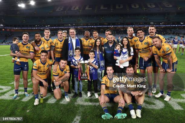 Leila and Danny Abdallah along with their children pose with the i4Give Cup with the Parramatta Eels players after winning the round 15 NRL match...