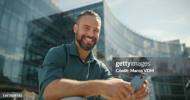 laughing, city and face of a man with a phone for communication, social media and mobile app. smile, break and employee portrait on stairs in town with a cellphone for conversation and reading a text - mid volwassen mannen stockfoto's en -beelden