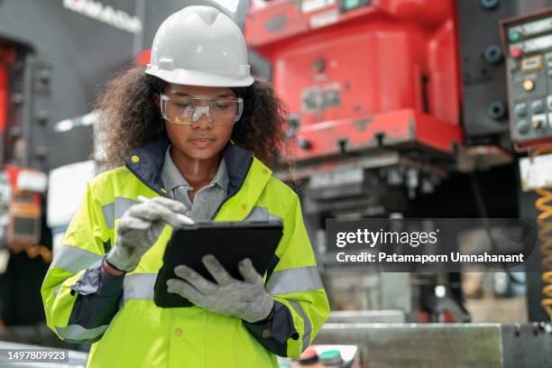 optimization in the production process contributes to productivity. production engineer female standing in the factory using digital tablet tracking part of machine breakdown and inspector on the shelf in the production line. - accuracy stock pictures, royalty-free photos & images