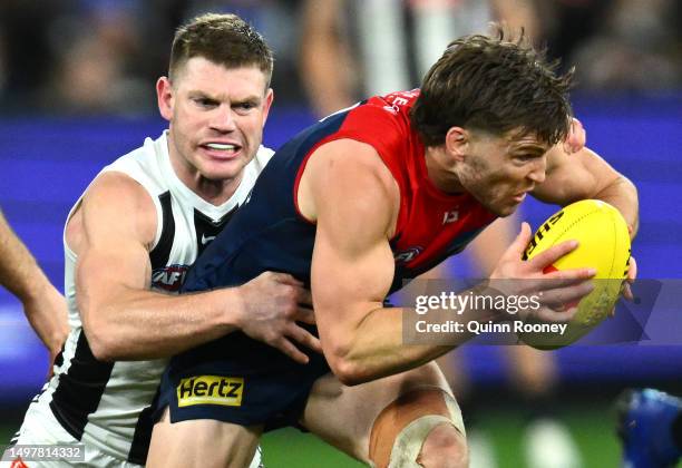 Jack Viney of the Demons is tackled by Taylor Adams of the Magpies during the round 13 AFL match between Melbourne Demons and Collingwood Magpies at...