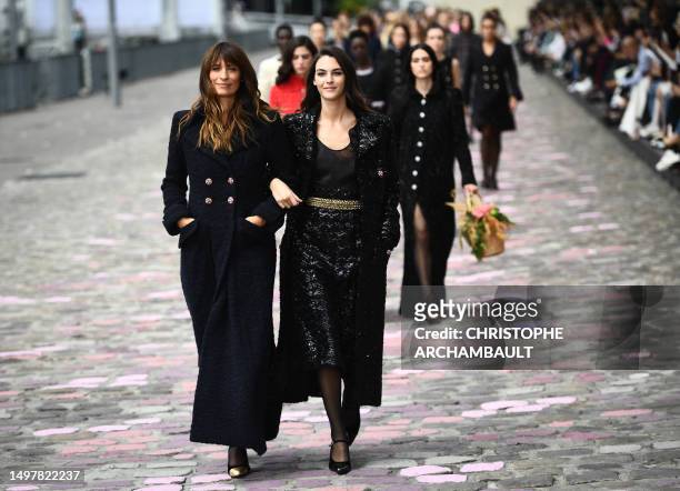 French model and music producer Caroline de Maigret and Vittoria Ceretti walk with models as they present creations by Chanel during the Women's...