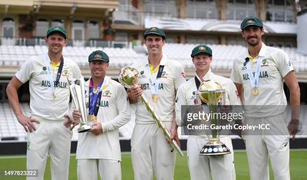 Josh Hazlewood, David Warner, Pat Cummins, Steve Smith and Mitchell Starc of Australia pose with the ICC World Cup, ICC World Test Championship Mace...