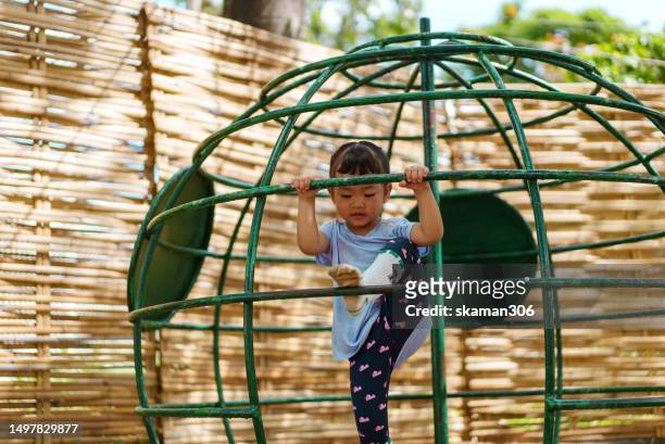 weekend activity asian female toddler motivate climbing up playground active sport - extreem weer stock pictures, royalty-free photos & images