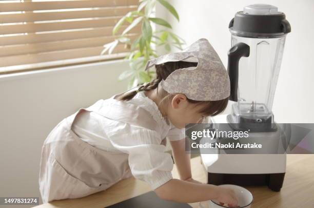 girl making cookies - ボウル stock pictures, royalty-free photos & images