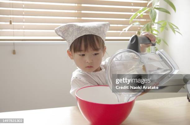 girl making cookies - ボウル stock pictures, royalty-free photos & images