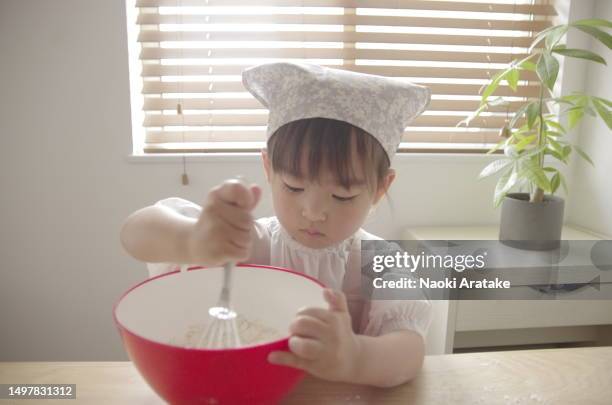 girl making cookies - ボウル stock pictures, royalty-free photos & images