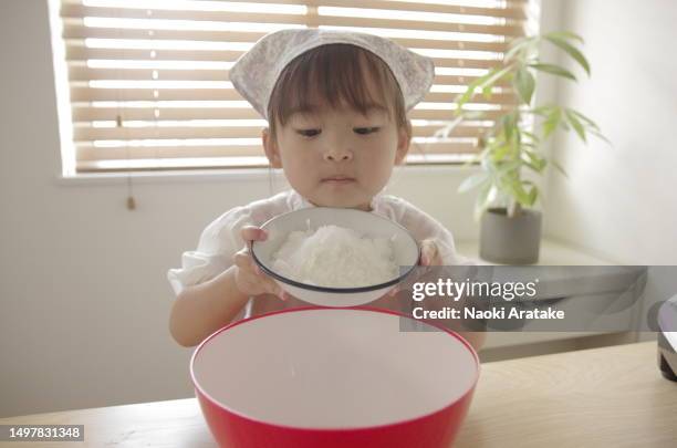 girl making cookies - ボウル stock pictures, royalty-free photos & images