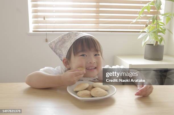 girl making cookies - ボウル stock pictures, royalty-free photos & images