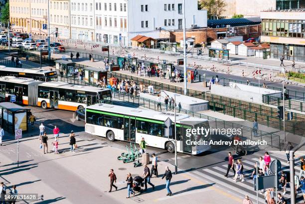 busy street in gdansk city centre with buses, tram stop, and pedestrians. - pomorskie province stock pictures, royalty-free photos & images