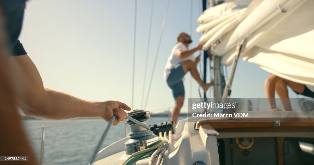 Boat, sailing and men working with rope on winch for travel, adventure or journey at sea with crew hands. Friends or people together to work on sailboat rig for transportation and freedom on ocean