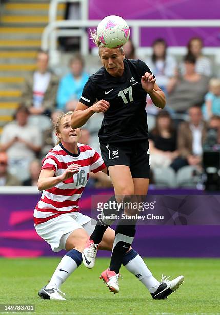 Hannah Wilkinson of New Zealand heads while Rachel Buehler of USA looks on during the Women's Football Quarter Final match between United States and...