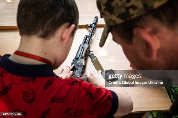 Children are shown weapons and taught to disassemble and assemble them on June 9, 2023 in Kyiv, Ukraine. With the beginning of the full-scale...