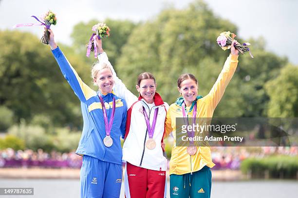 Silver medalist Lisa Norden of Sweden, Gold medalist Nicola Spirig of Switzerland, and Bronze medalist Erin Densham of Australia pose with their...