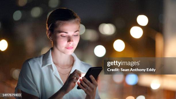 city lights,woman and smartphone for social media scroll, post and global networking on mobile app. person on phone or cellphone in night bokeh for online chat, web 3.0 or internet - electronic banking stock pictures, royalty-free photos & images