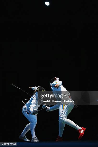 Britta Heidemann of Germany competes against Anfisa Pochkalova of Ukraine during the Women's Epee Team Fencing classification 5-8 match on Day 8 of...