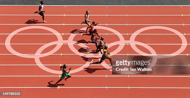 Usain Bolt of Jamaica leads James Dasaolu of Great Britain in the Men's 100m Round 1 Heats on Day 8 of the London 2012 Olympic Games at Olympic...