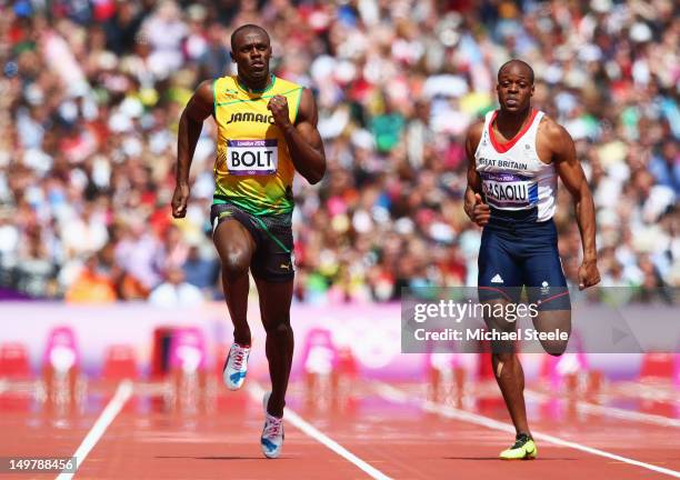 Usain Bolt of Jamaica and James Dasaolu of Great Britain compete in the Men's 100m Round 1 Heats on Day 8 of the London 2012 Olympic Games at Olympic...