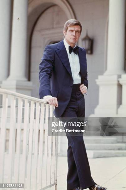 American actor Lee Majors posing in a suit and bow tie at an unspecified location, 1975.