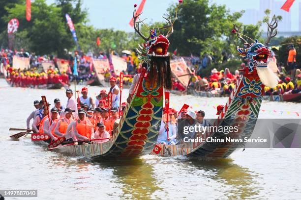 Participants compete during the thousand-year-old folk custom "Rowing-Dragon-Boat" competition on June 12, 2023 in Putian, Fujian Province of China.